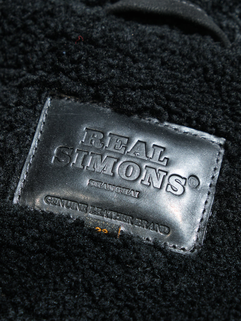 black trademark on a farmers leather jacket