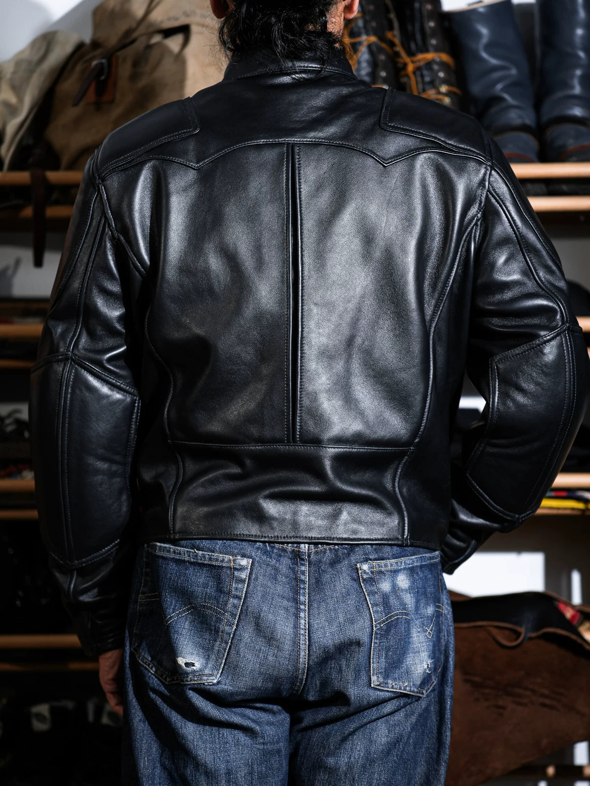 Rear three-quarter view of the BRIXTON black sheepskin jacket with back seam detailing