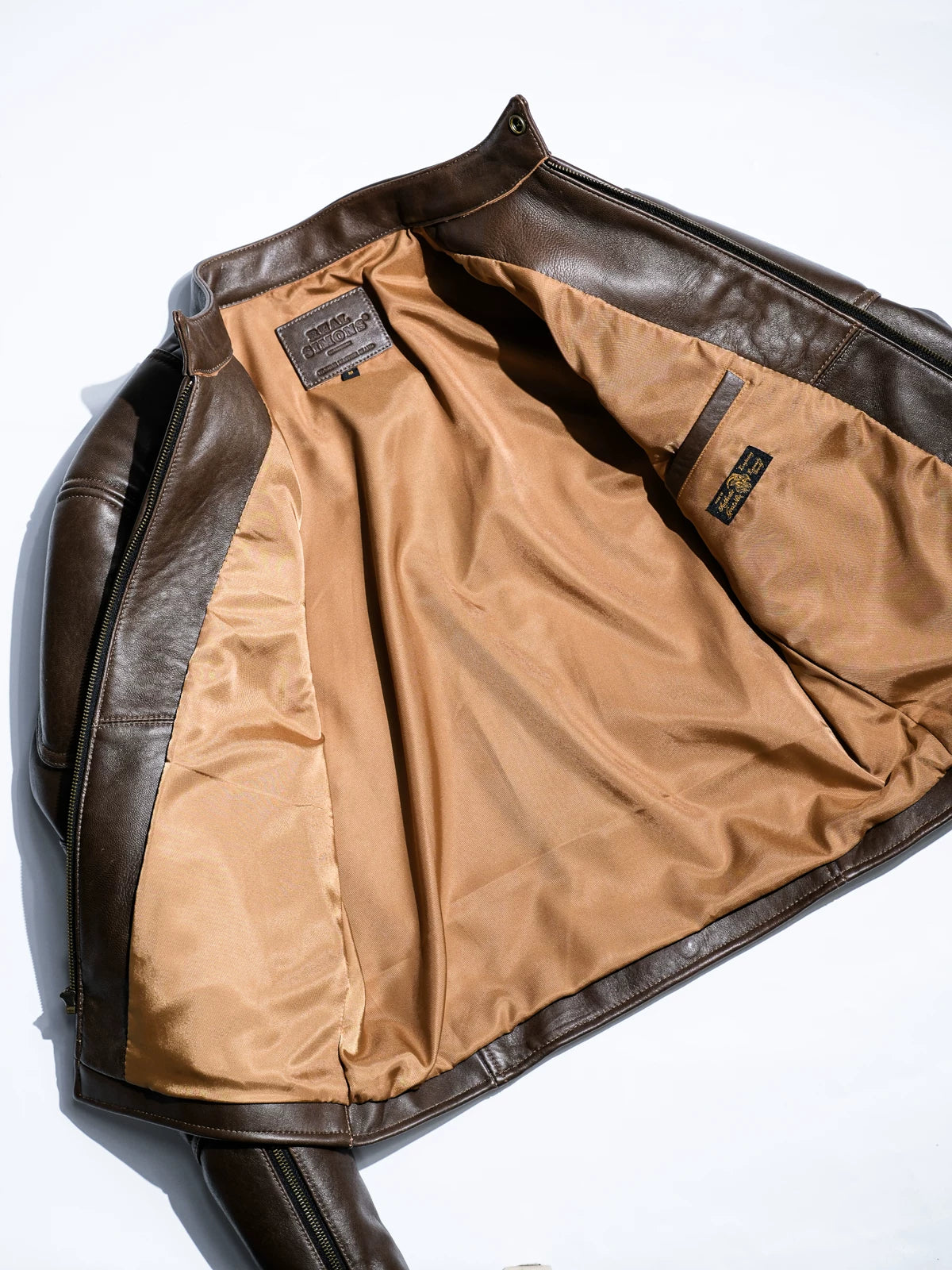Inside of BRIXTON brown jacket with light camel lining and Real Simons leather label