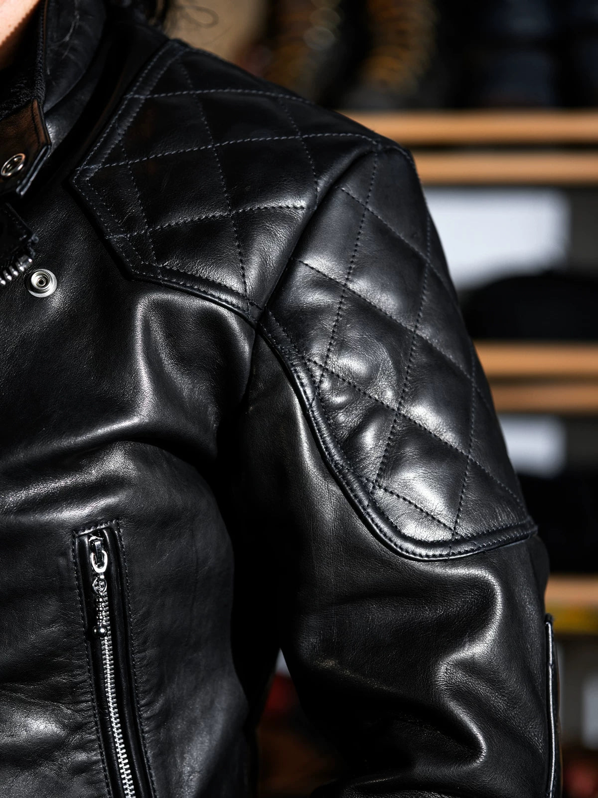 Close-up of MALLORY IMOLA jacket shoulder with full diamond-quilt reinforcement and snap hardware
