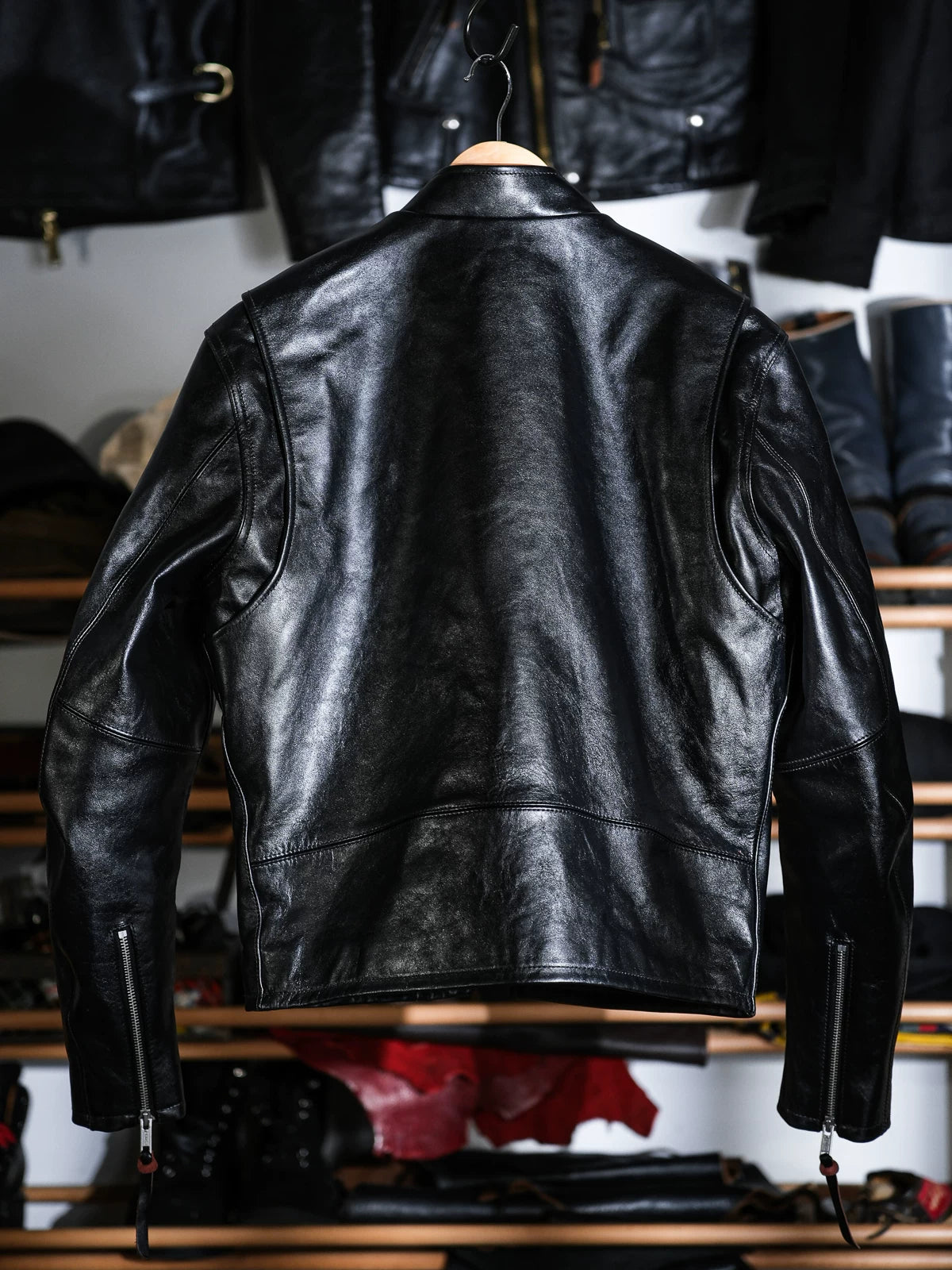 Back view of the Mojave jacket on a hanger with zipped cuffs