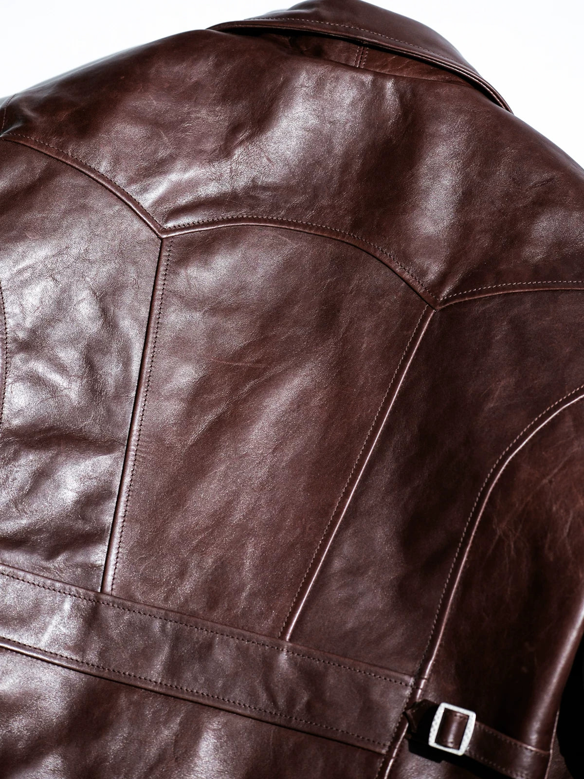 Parachute back yoke panel stitching close-up on chestnut seal brown horsehide