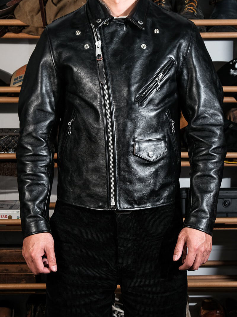 Black beltless riders jacket styled on model showing asymmetric zip and pockets