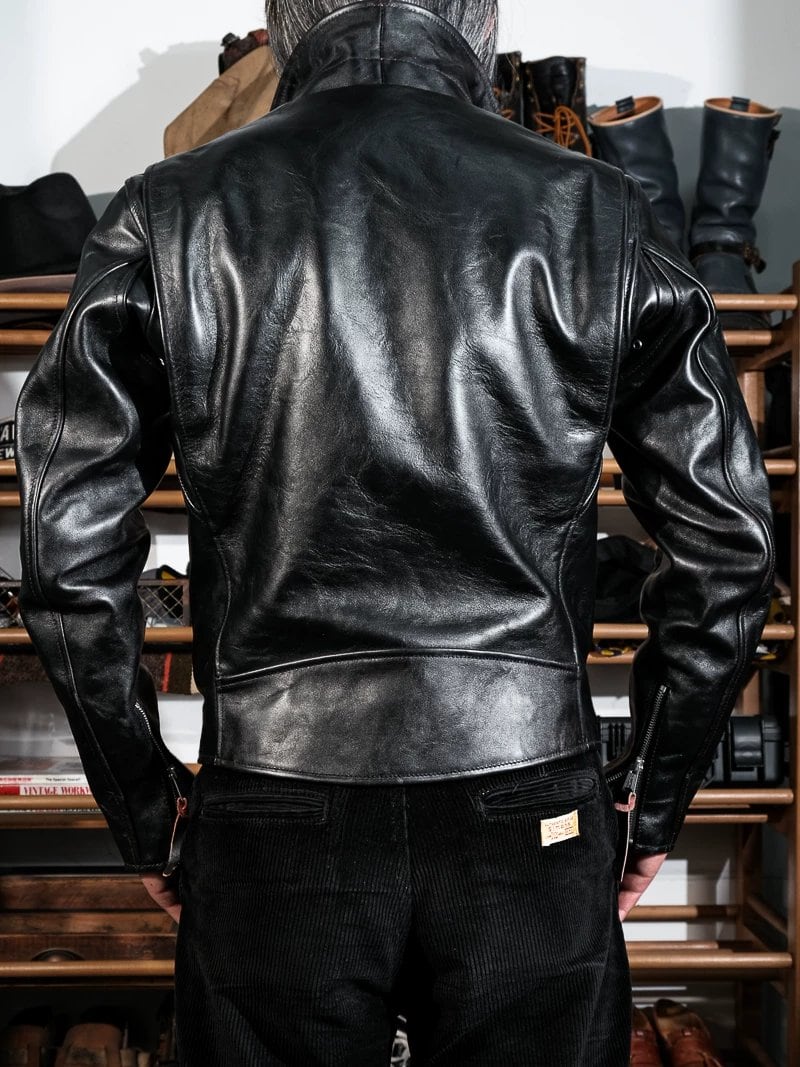 Back view of black beltless horsehide jacket with corduroy pants