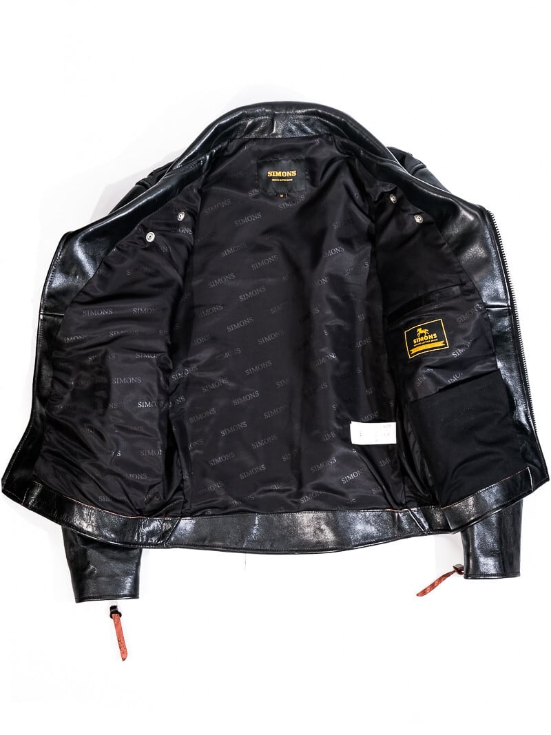 Inside of black riders jacket showing SIMONS jacquard lining