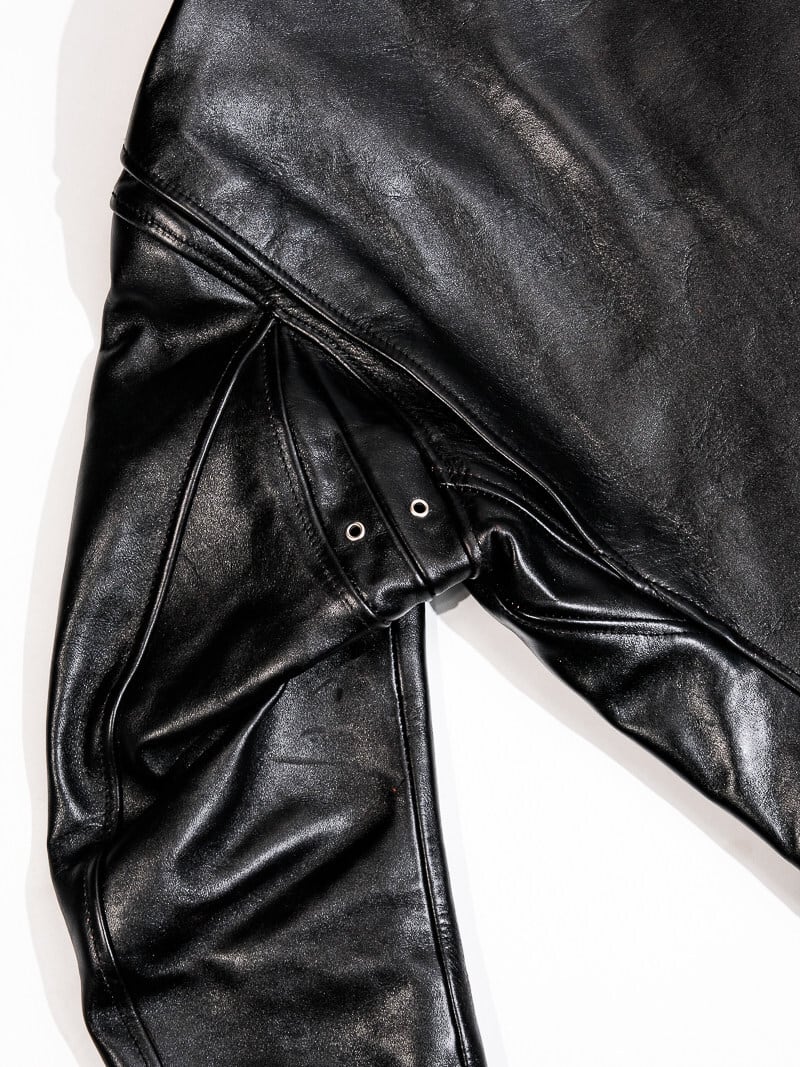Black jacket shoulder seam detail with metal eyelets