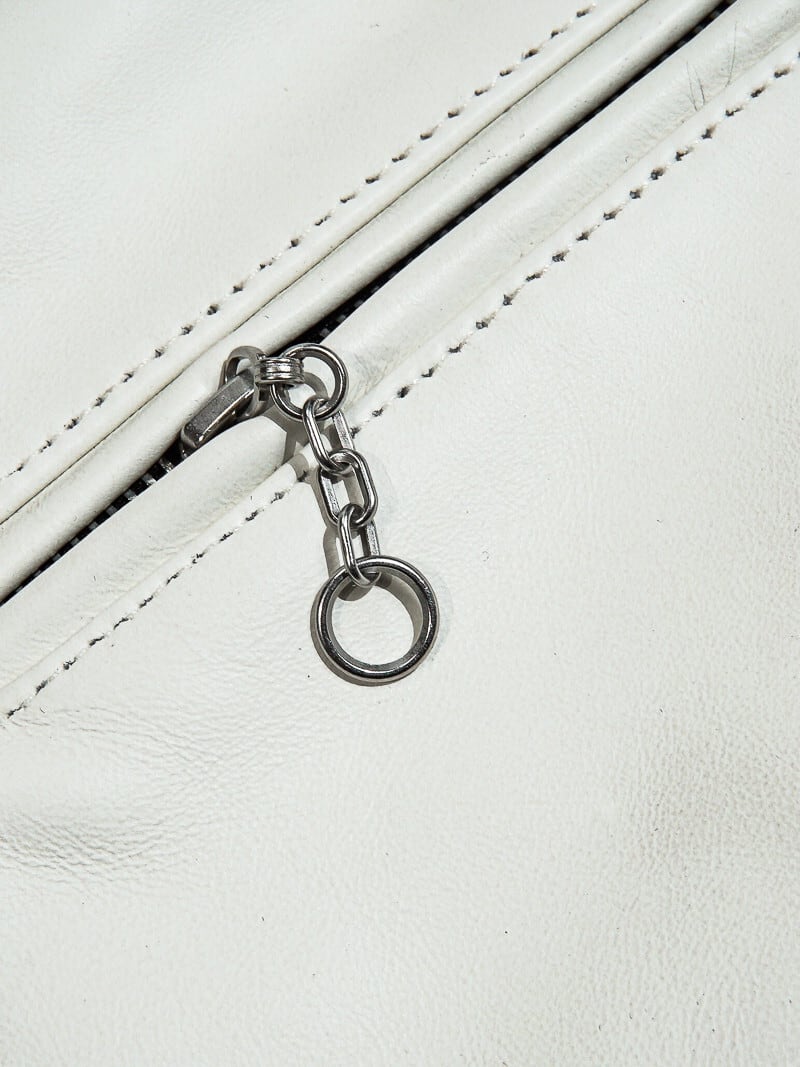 White jacket pocket zipper with chain pull and ring