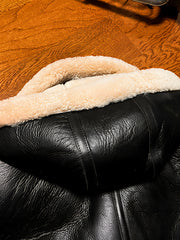 Black-sheepskin-jacket-with-hood-on-the-back