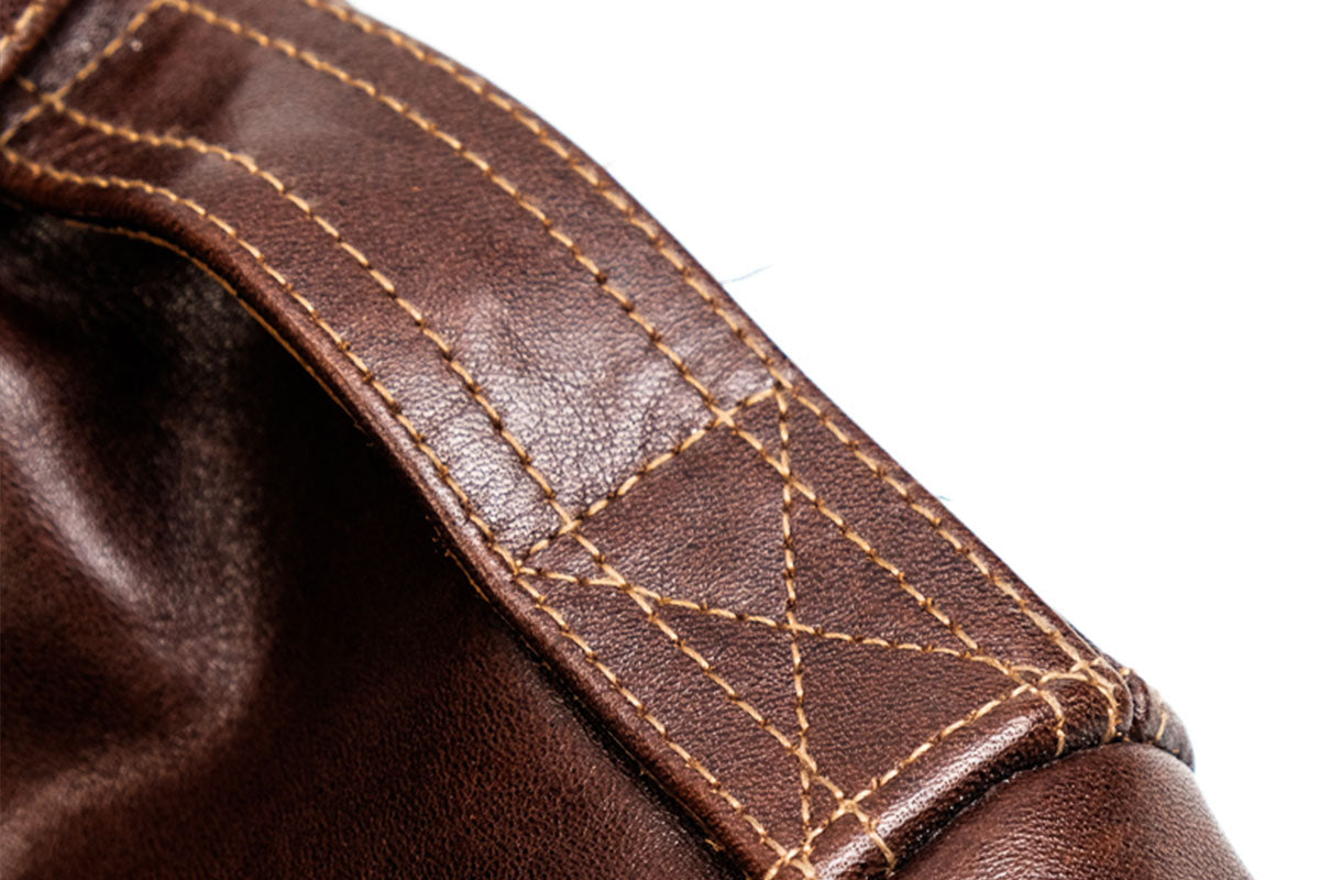 Closeup of shoulder straps and period-correct brown-green contrast stitching on 18775 A-2 leather bomber jacket