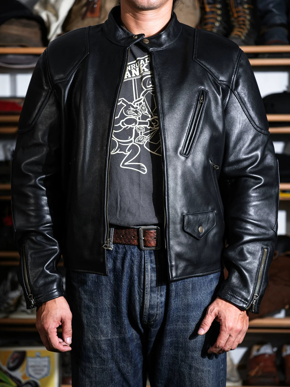 BRIXTON padded racing jacket in black sheepskin styled with jeans and leather belt