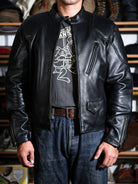 BRIXTON padded racing jacket in black sheepskin styled with jeans and leather belt