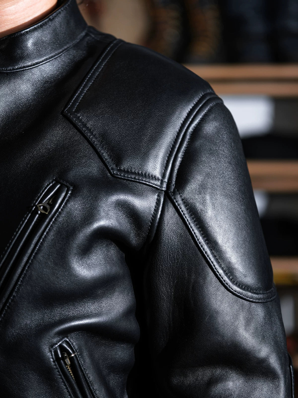 Close-up of BRIXTON jacket shoulder, collar and chest with visible reinforcement panels