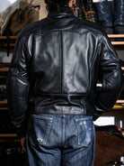Rear three-quarter view of the BRIXTON black sheepskin jacket with back seam detailing