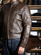 BRIXTON padded racing jacket in brown sheepskin styled on model with jeans