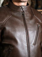 Close-up of BRIXTON brown jacket chest, collar and zip pockets