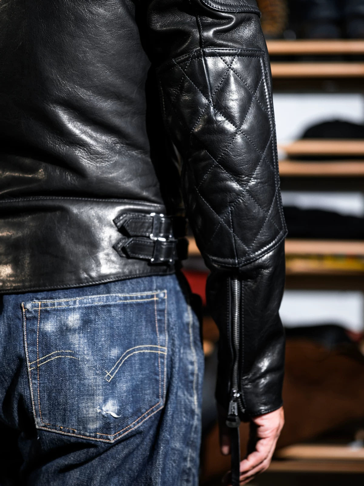 Back view of MALLORY IMOLA British racing jacket with diamond-quilted sleeves and waist adjuster straps