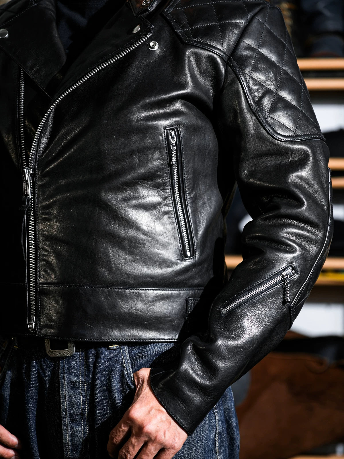 MALLORY IMOLA jacket front detail showing the zippered chest pocket, sleeve zip pocket and offset front zipper