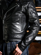MALLORY IMOLA jacket front detail showing the zippered chest pocket, sleeve zip pocket and offset front zipper