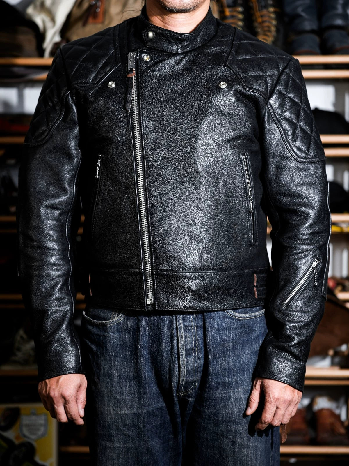 MALLORY IMOLA jacket in tea-core cowhide worn open, showing stand collar, quilted shoulders and zippered pockets