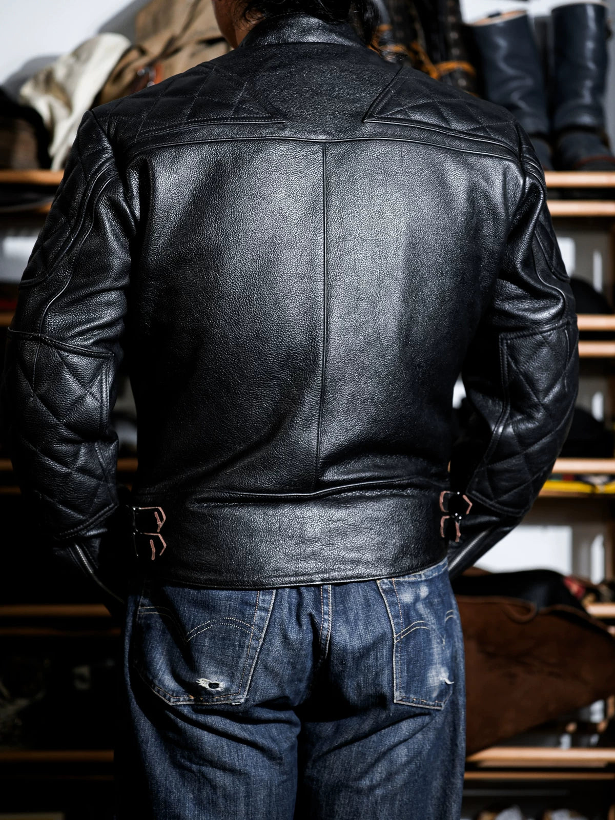 Back view of the MALLORY IMOLA tea-core cowhide jacket with quilted sleeves and side waist adjusters