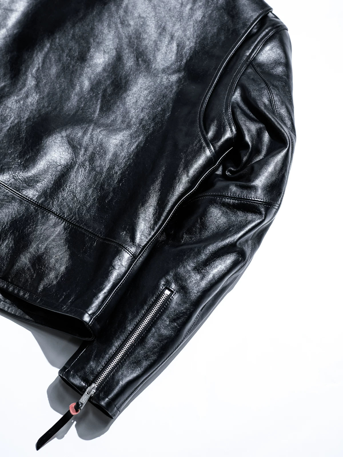 Mojave jacket sleeve zipper detail with black leather pull and red accent