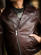 Chest close-up of diagonal zipper and wide lapel on chestnut seal brown horsehide