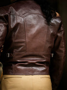 Back view of seal brown horsehide showing parachute yoke, half-belt and side adjuster straps