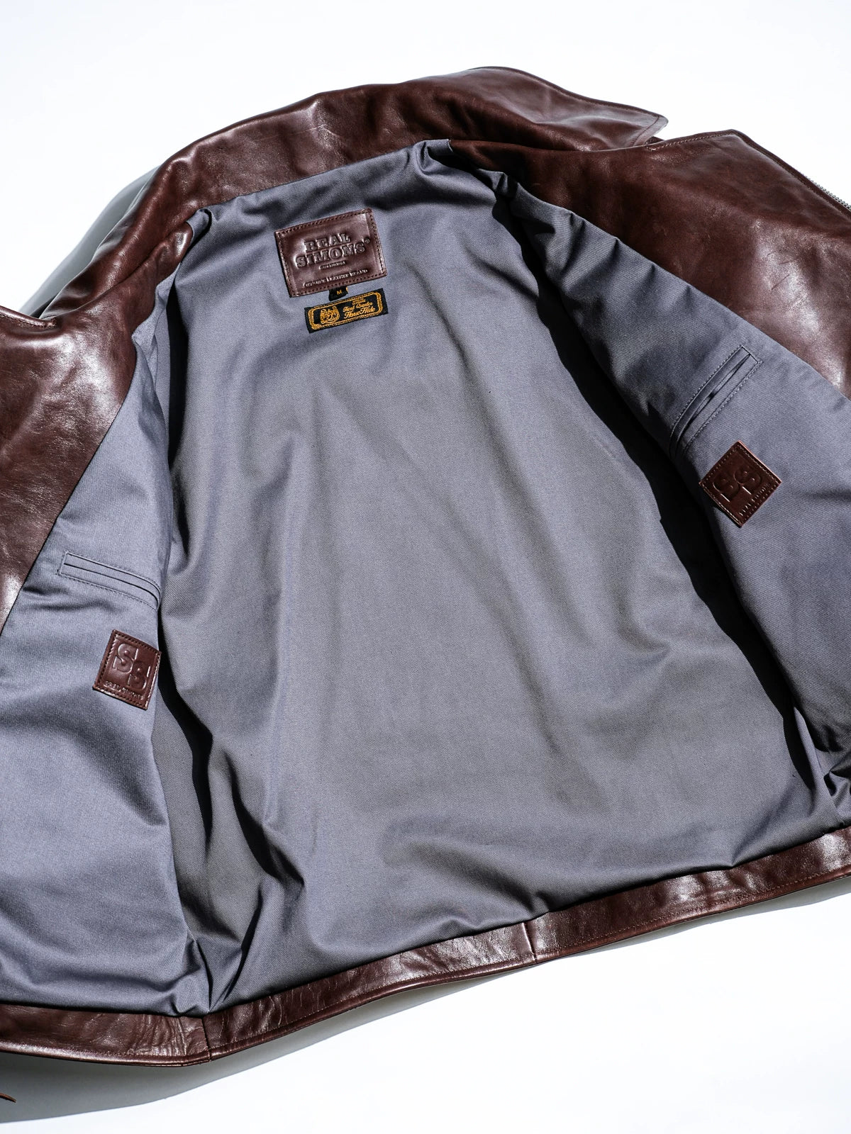 Full interior of grey TC cotton-blend twill lining with interior pockets and brown SS leather tabs
