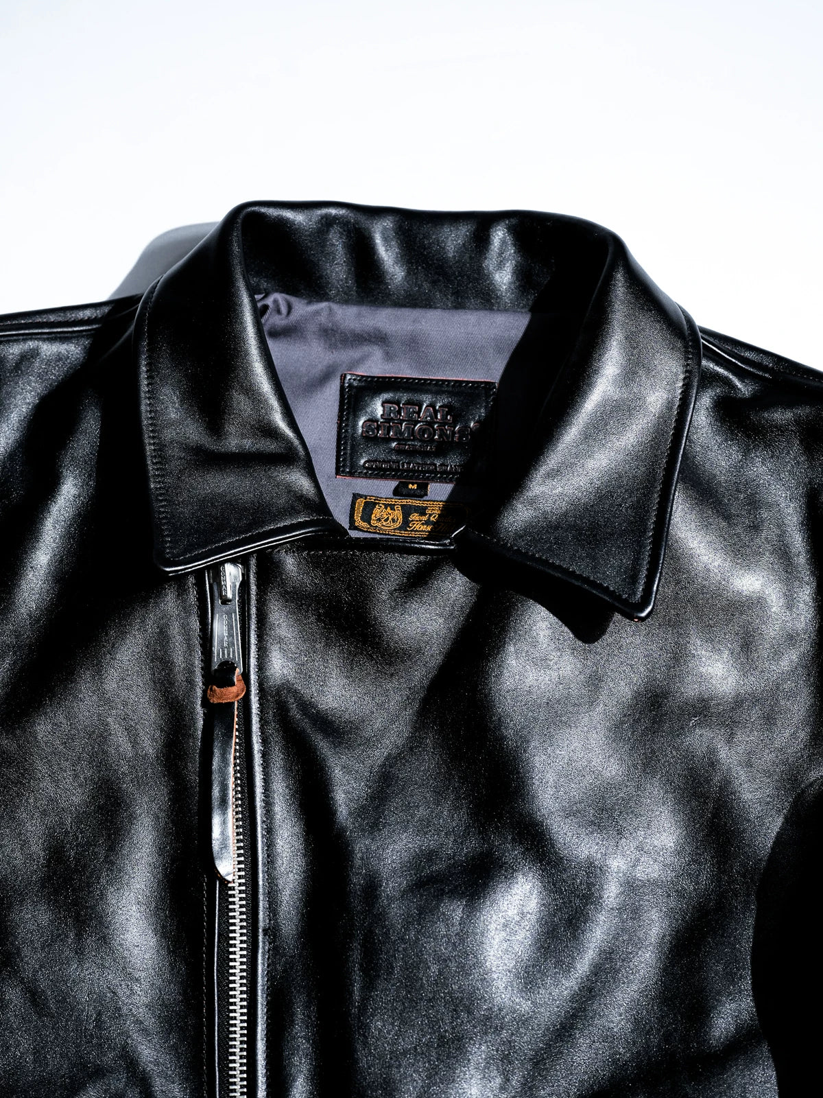 Flat lay stand collar with engraved diagonal zipper pull on black horsehide