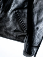 Angled muff pocket and shirt cuff construction detail in black tea-core horsehide