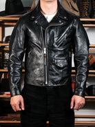 Urban riders beltless jacket in black horsehide worn with henley and corduroy pants, front view