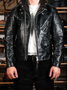 Black urban riders jacket front view with rivets, zip pockets and lapel collar