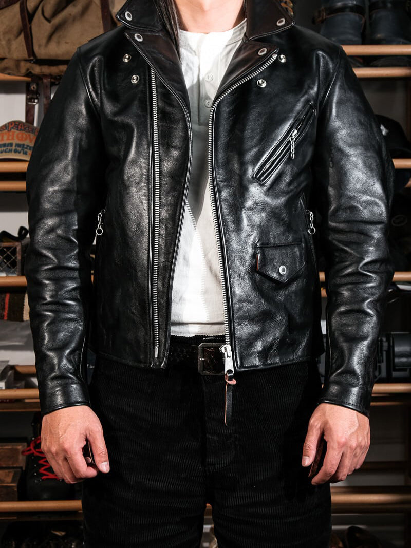 Black urban riders jacket front view with rivets, zip pockets and lapel collar