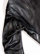 Black jacket shoulder seam detail with metal eyelets