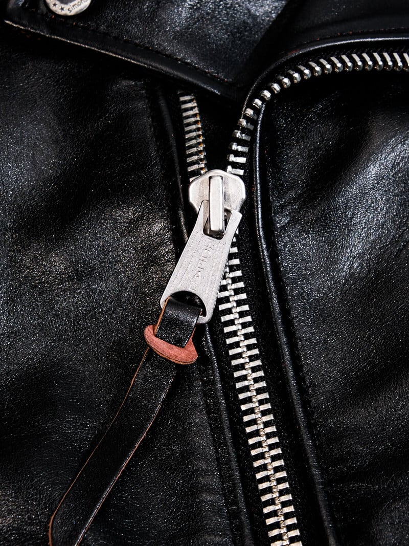 TALON zipper detail on the black beltless jacket