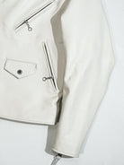 White jacket front pocket detail with zip and snap closures